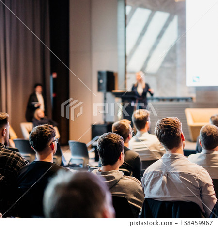 Female speaker giving a talk on corporate business conference. Unrecognizable people in audience at conference hall. Business and Entrepreneurship event Female speaker giving a talk on corporate business conference. Unrecognizable people in audience at conference hall. Business and Entrepreneurship event 138459967