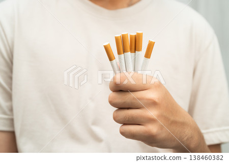 Man holding cigarette, no smoking. Man holding cigarette, no smoking. 138460382