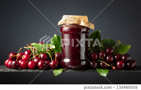 Cherry jam and fresh berries on a black background. 138460856