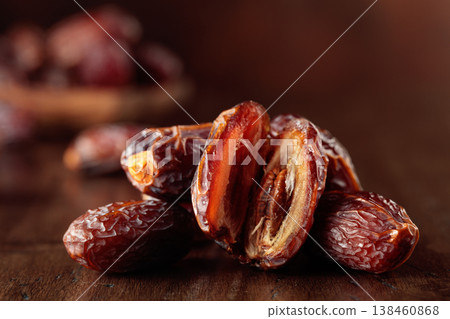 Dates fruit on an old wooden table. Dates fruit on an old wooden table. 138460868