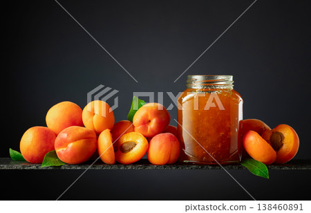 Apricot jam in glass jar and fresh fruits. Apricot jam in glass jar and fresh fruits. 138460891