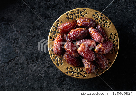 Dates fruits on black stone table. Dates fruits on black stone table. 138460924