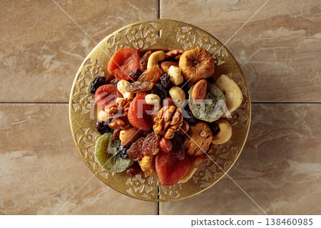 Assortment of dried tropical fruits, nuts and raisins. Assortment of dried tropical fruits, nuts and raisins. 138460985