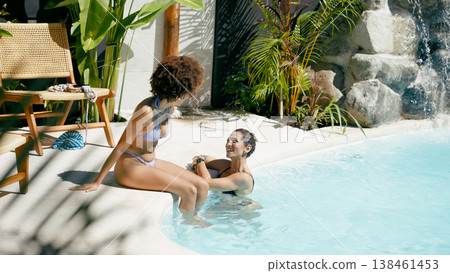Friends enjoying tropical pool relaxation during summer vacation Friends enjoying tropical pool relaxation during summer vacation 138461453