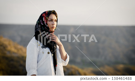 Muslim woman wearing headscarf in desert landscape 138461488