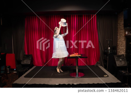 A woman performing magic tricks on stage A woman performing magic tricks on stage 138462011