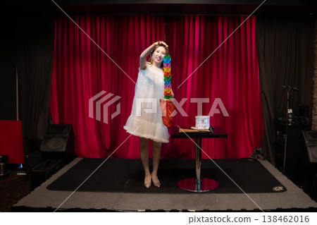 A woman performing magic tricks on stage A woman performing magic tricks on stage 138462016