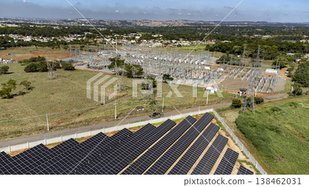 Aerial view of solar panels connected to electricity substation 138462031