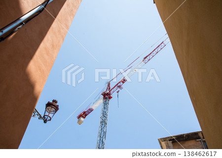 An old stone apartment building undergoing renovations under a clear blue sky, on the French island of Corsica in the Mediterranean Sea. An old stone apartment building undergoing renovations under a clear blue sky, on the French island of Corsica in the Mediterranean Sea. 138462617