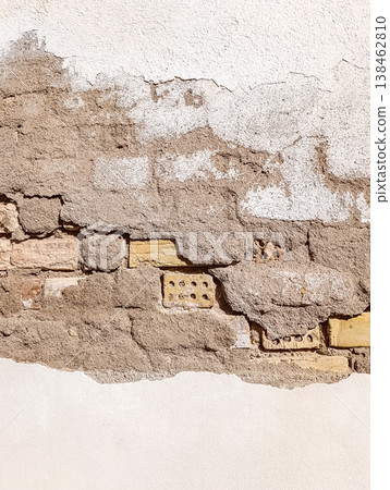 Peeling White Painted Wall with Exposed Old Bricks in Sunlight vertical Peeling White Painted Wall with Exposed Old Bricks in Sunlight vertical 138462810