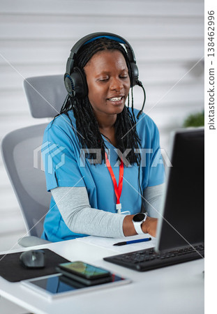 African American woman with headset providing telemedicine service 138462996