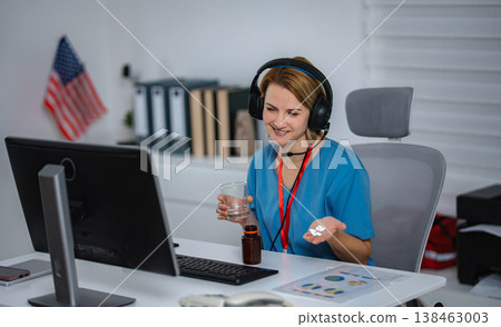 Smiling nurse on a video call helping a patient with prescription pills and water Smiling nurse on a video call helping a patient with prescription pills and water 138463003