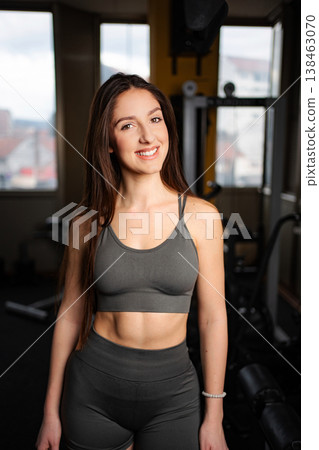 Young woman smiling in gym showing fitness lifestyle 138463070