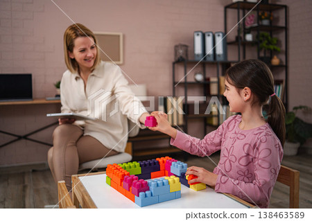 Child playing with building blocks in therapist office Child playing with building blocks in therapist office 138463589