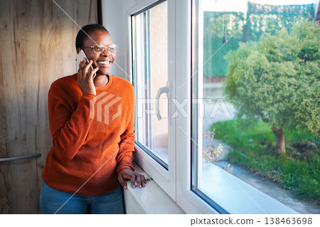 Happy young adult woman talking on smartphone 138463698