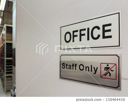 Office space signage indicating a restricted area for staff in a professional environment 138464438