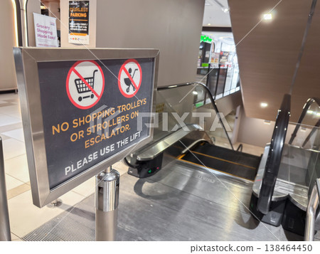 No shopping trolleys or strollers allowed on escalator in public shopping area in Penang Malaysia No shopping trolleys or strollers allowed on escalator in public shopping area in Penang Malaysia 138464450