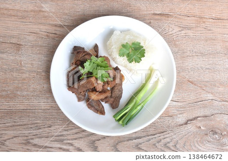 salty dry fried slice beef meat fermenting in sesame oil and pepper with sticky rice topping parsley on plate 138464672