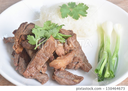 salty dry fried slice beef meat fermenting in sesame oil and pepper with sticky rice topping parsley on plate salty dry fried slice beef meat fermenting in sesame oil and pepper with sticky rice topping parsley on plate 138464673