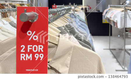 Clothing sale display in Penang, Malaysia with promotional offer on shirts showcased Clothing sale display in Penang, Malaysia with promotional offer on shirts showcased 138464793
