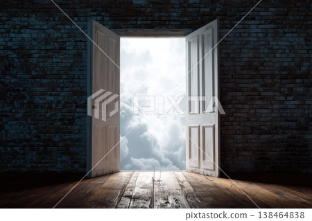 Open doorway shines with bright clouds against a dark brick wall, illuminating possibility and hope, creating a sense of escape. 138464838