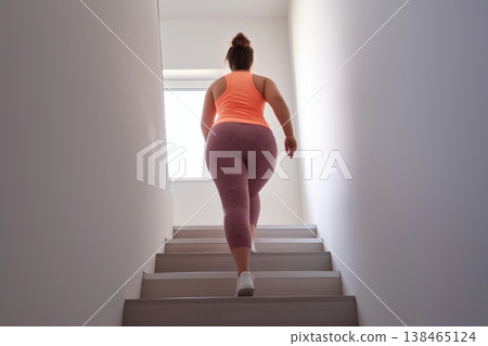 Plump Young Woman Engages in Stair Climbing Exercise 138465124