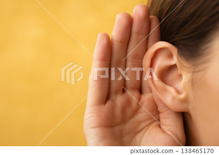 A Human Ear and Hand Cupped Behind to Listen Closely A Human Ear and Hand Cupped Behind to Listen Closely 138465170