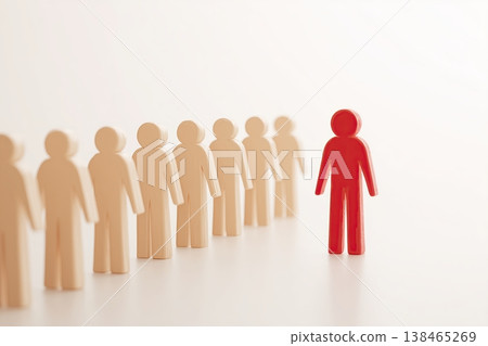 Red figure stands out from the beige crowd, symbolizing leadership and individuality in a concept of distinction. Red figure stands out from the beige crowd, symbolizing leadership and individuality in a concept of distinction. 138465269