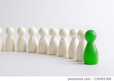 Green figure stands out among white figures in leadership demonstration on clean background. Green figure stands out among white figures in leadership demonstration on clean background. 138465306