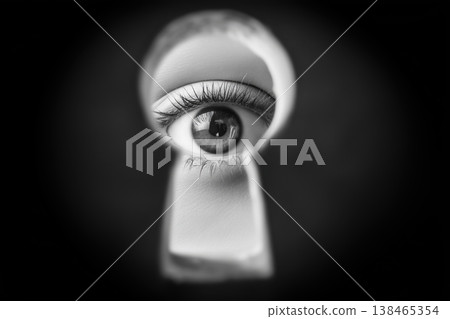 Human eye peers through a keyhole in a striking monochromatic close up creating a sense of mystery Human eye peers through a keyhole in a striking monochromatic close up creating a sense of mystery 138465354