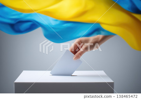 Ukrainian elections are portrayed with a hand placing a ballot into the voting box against a background featuring the national flag. Ukrainian elections are portrayed with a hand placing a ballot into the voting box against a background featuring the national flag. 138465472
