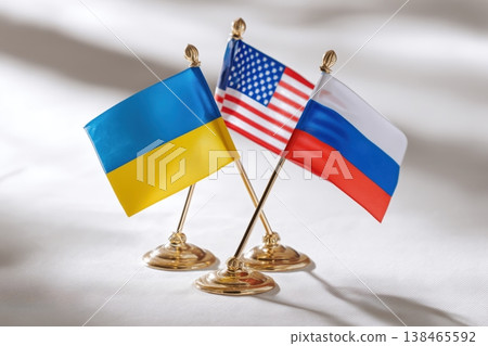 A trio of table flags featuring Ukraine, the United States, and Russia represents geopolitical relationships and diplomacy. A trio of table flags featuring Ukraine, the United States, and Russia represents geopolitical relationships and diplomacy. 138465592