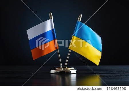 Two flags, Russia and Ukraine, stand on a dark surface, symbolizing the current conflict and international relations. Two flags, Russia and Ukraine, stand on a dark surface, symbolizing the current conflict and international relations. 138465598