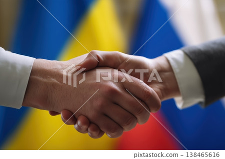 Diplomacy shown with a handshake between Russia and Ukraine set against their national flags emphasizing global politics 138465616