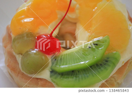 Delicious fruit tart with glazed cherry kiwi and orange slices for sweet bakery dessert concept Delicious fruit tart with glazed cherry kiwi and orange slices for sweet bakery dessert concept 138465843
