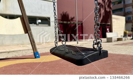 Empty black and gris swing on sandy playground for children, no people 138466266
