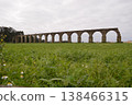 Part of a ruined ancient aqueduct in Portugal. Concept of historical values, architecture, and tourism. 138466315