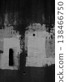 Black and white vertical photograph of a dirty concrete wall with splash background material. 138466750