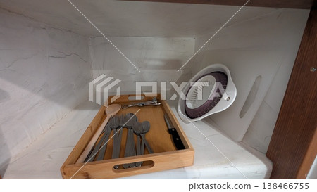 Kitchen utensils in wooden tray in the white cabinet Kitchen utensils in wooden tray in the white cabinet 138466755