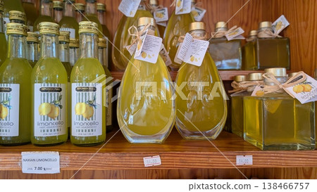 Local produce of limoncellos in bottles on the shelf of the store for sale Local produce of limoncellos in bottles on the shelf of the store for sale 138466757