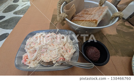 Crab salad, bread and olive paste on a restaurant table Crab salad, bread and olive paste on a restaurant table 138466760