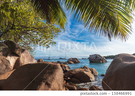 Tropical beach scene with large granite boulders 138466991