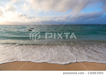Gentle waves wash over a sandy shoreline, Seychelles 138467003