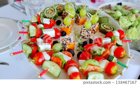 Beautifully decorated banquet table featuring an array of colorful snacks and appetizers, including cheese, vegetables, and grapes, perfect for any celebration Beautifully decorated banquet table featuring an array of colorful snacks and appetizers, including cheese, vegetables, and grapes, perfect for any celebration 138467167