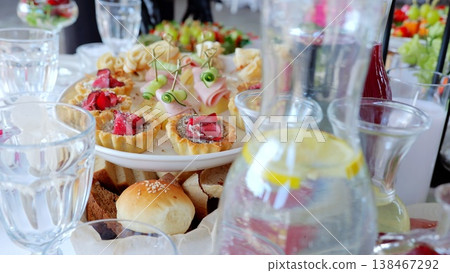 Gourmet appetizers and vibrant beverages artfully positioned, showcasing sophisticated party preparation with elegant culinary presentation 138467292