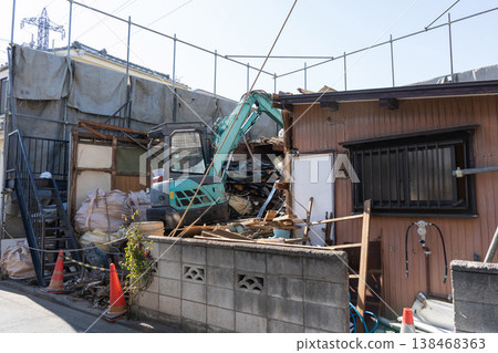 A scene from a house demolition project: heavy machinery is used to demolish a building (3). A scene from a house demolition project: heavy machinery is used to demolish a building (3). 138468363