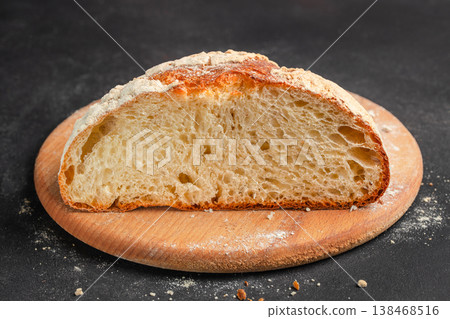 Half loaf of artisan sourdough bread showing crumb texture on wooden board Half loaf of artisan sourdough bread showing crumb texture on wooden board 138468516