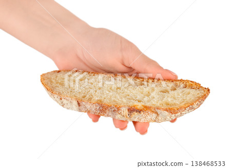 Female hand holding sourdough bread slice isolated on light background Female hand holding sourdough bread slice isolated on light background 138468533