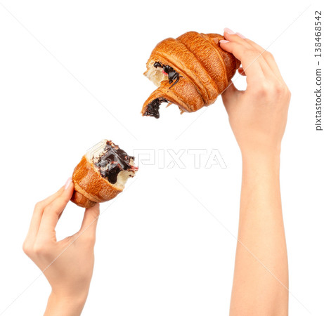 Woman hands holding bitten chocolate croissant isolated on light background with copy space 138468542