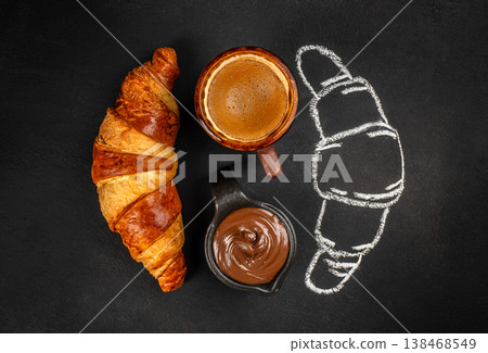 Croissant with coffee and chocolate spread on black background, top view 138468549